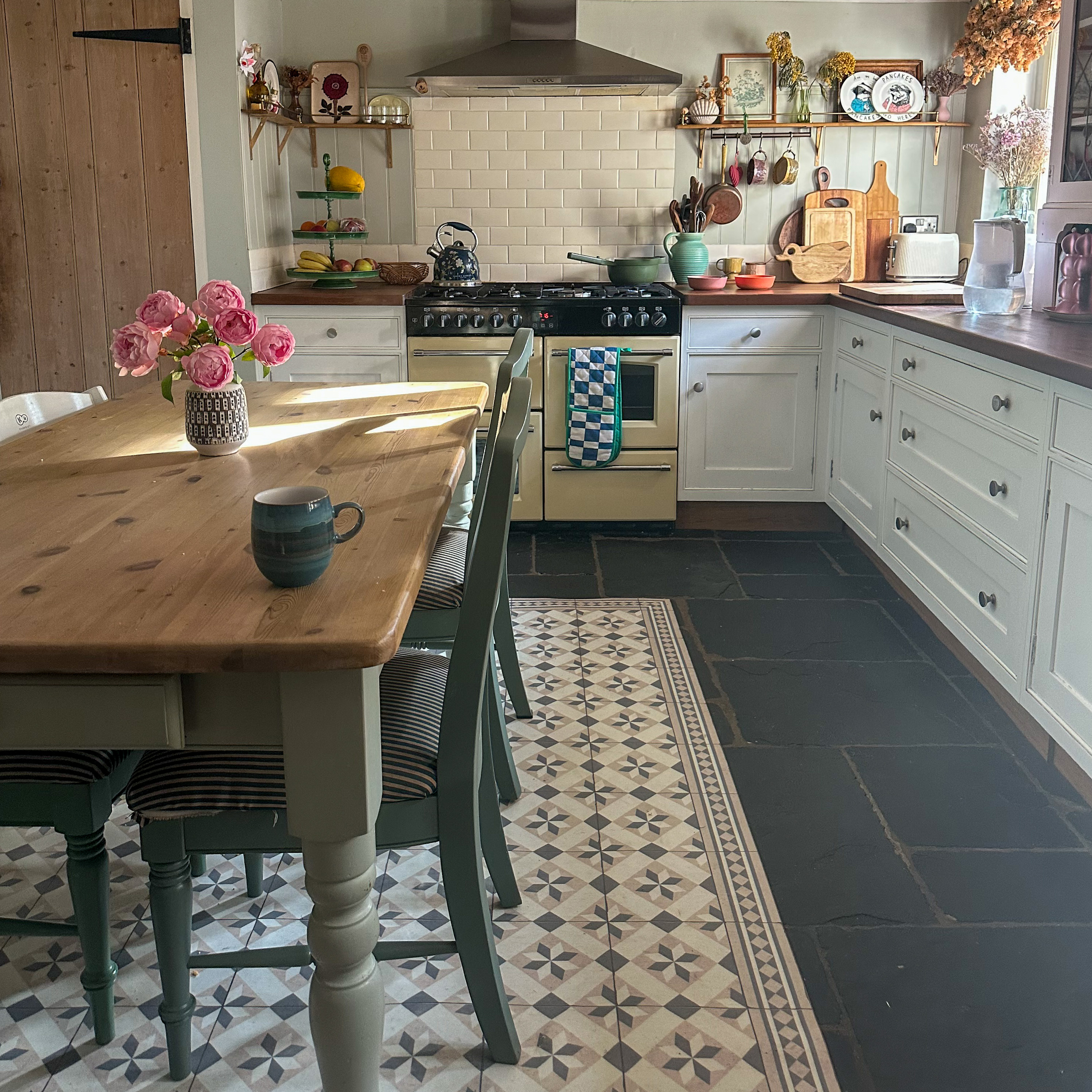 country kitchen with white cabinets and farmhouse table