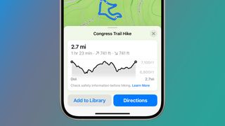An Phone on a green and blue background showing trails on Apple Maps