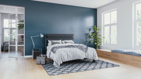 Interior of a modern bedroom decorated with modern furniture with pastel tones.