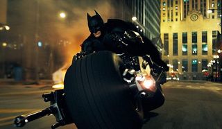 The Dark Knight Batman riding his motorcycle around Gotham