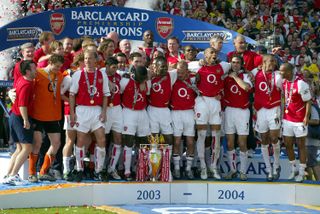 Arsenal players celebrate with the Premier League trophy after their Invincible season in 2003/04.