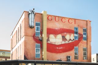 painting of red lips on a London wall