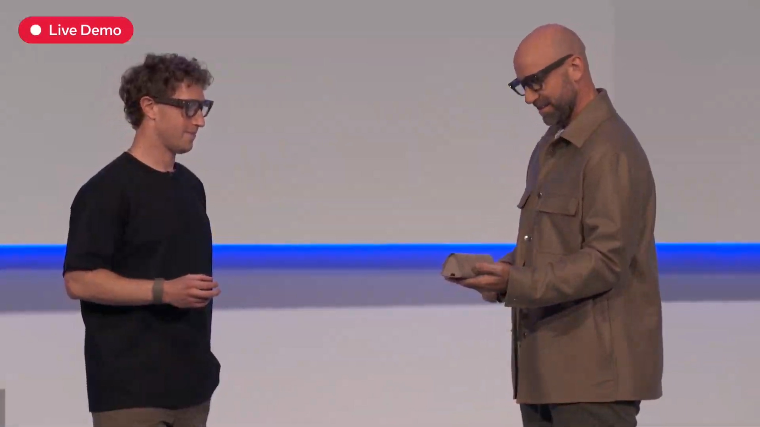Mark and Boz on stage showing off the folding charging case for Meta Ray-Ban Display Glasses