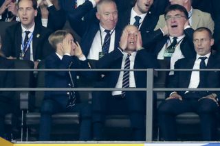 Prince George and Prince William attend a football match