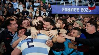 Rugby player celebrating with fans