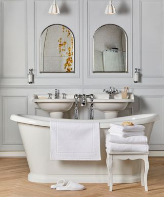 white towels in stool next to bath