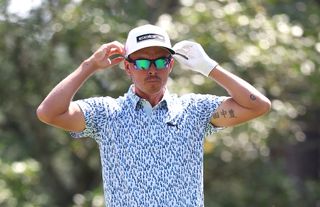 Rickie Fowler adjusts his sunglasses