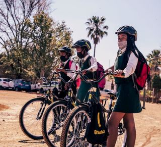 A group of schoolchidlren with Qhubeka bikes