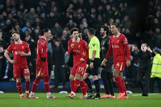 Liverpool's players chat to Curtis Jones after he was sent off against Everton