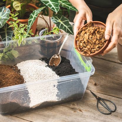 Soilless potting mix being made by gardener