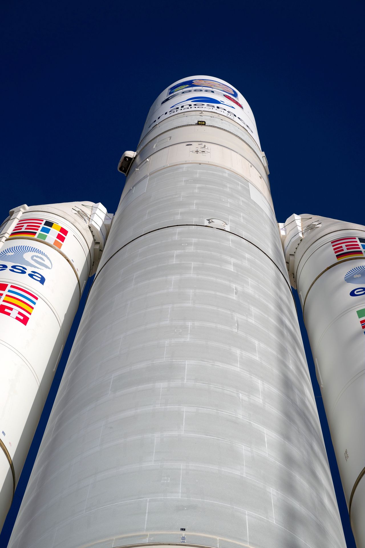 a view of a rocket from the perspective of standing below it looking up