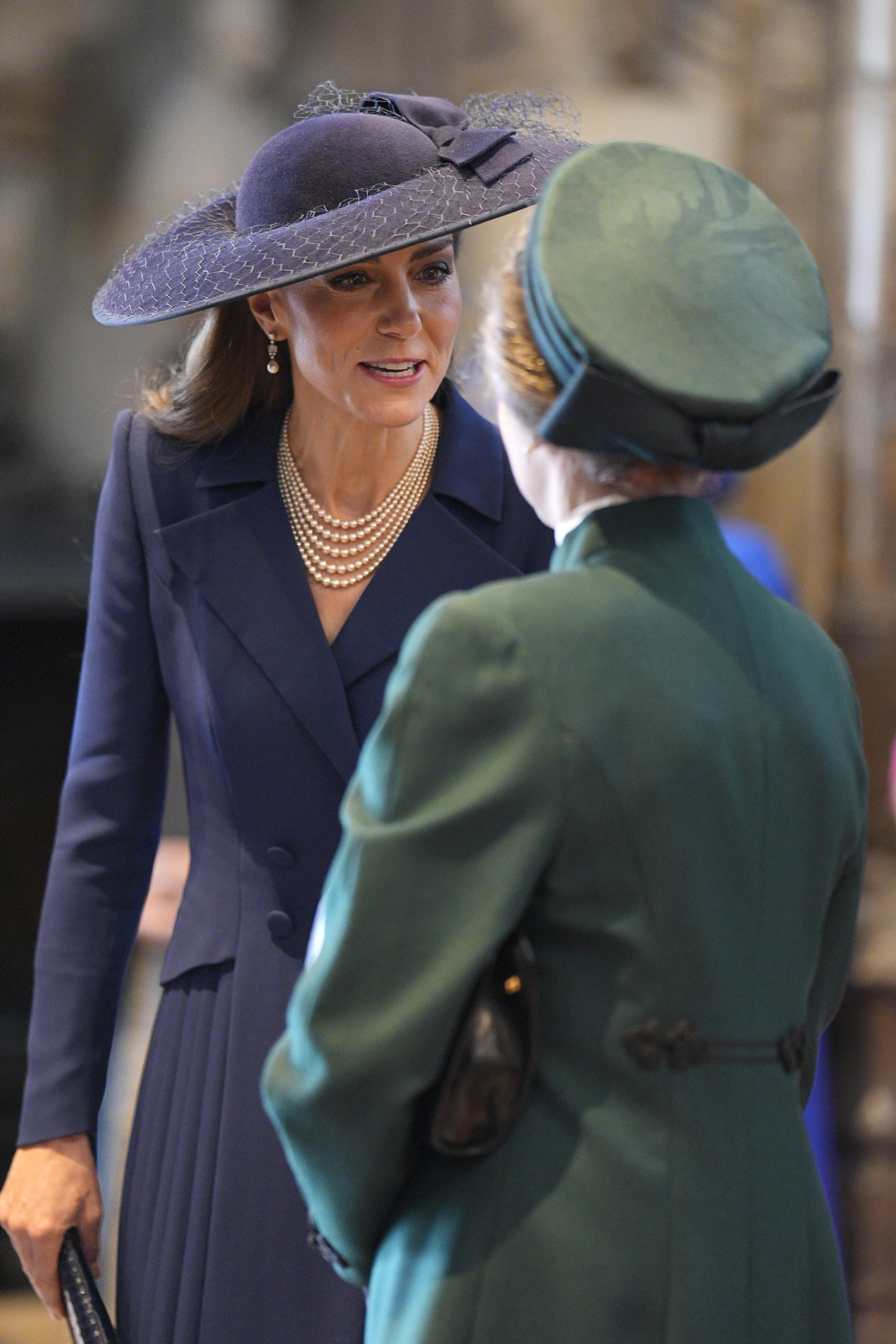 Kate Middleton wears a big blue hat and speaks with Princess Anne during the 2026 Commonwealth Day Service at Westminster Abbey on March 9, 2026 in London, England