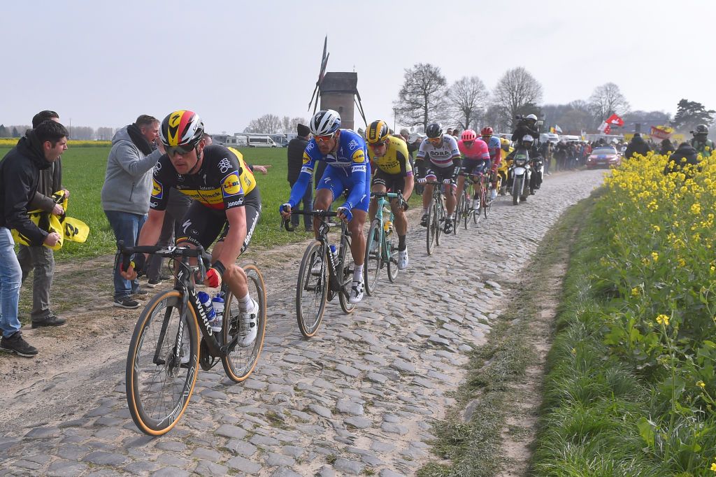 ROUBAIX FRANCE APRIL 14 Yves Lampaert of Belgium and Team DeceuninckQuickStep Philippe Gilbert of Belgium and Team DeceuninckQuickStep Wout Van Aert of Belgium and Team JumboVisma Peter Sagan of Slovakia and Team BORA hansgrohe Sep Vanmarcke of Belgium and Team EF Education First Nils Politt of Germany and Team KatushaAlpecin Windmill Peloton Cobblestones Fans Public during the 117th ParisRoubaix a 257km race from Compigne to Roubaix ParisRoubaix ParisRoubaix PRBX LEnfer du Nord on April 14 2019 in Roubaix France Photo by Luc ClaessenGetty Images