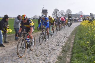 Yves Lampaert rides on cobbles in front of teammate Philippe Gilbert (Deceuninck-QuickStep), who would win 2019 Paris-Roubaix