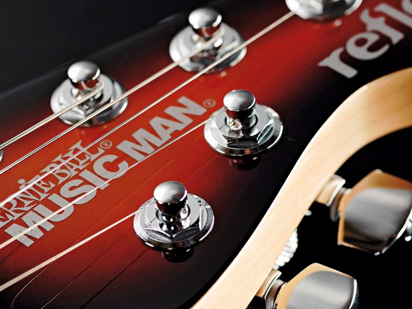 The familiar Music Man tuner arrangement allows straight string travel.