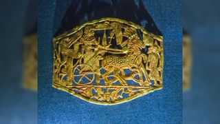 This golden buckle was found in Tutankhamun's tomb. It has a depiction of the pharaoh riding on his chariot.