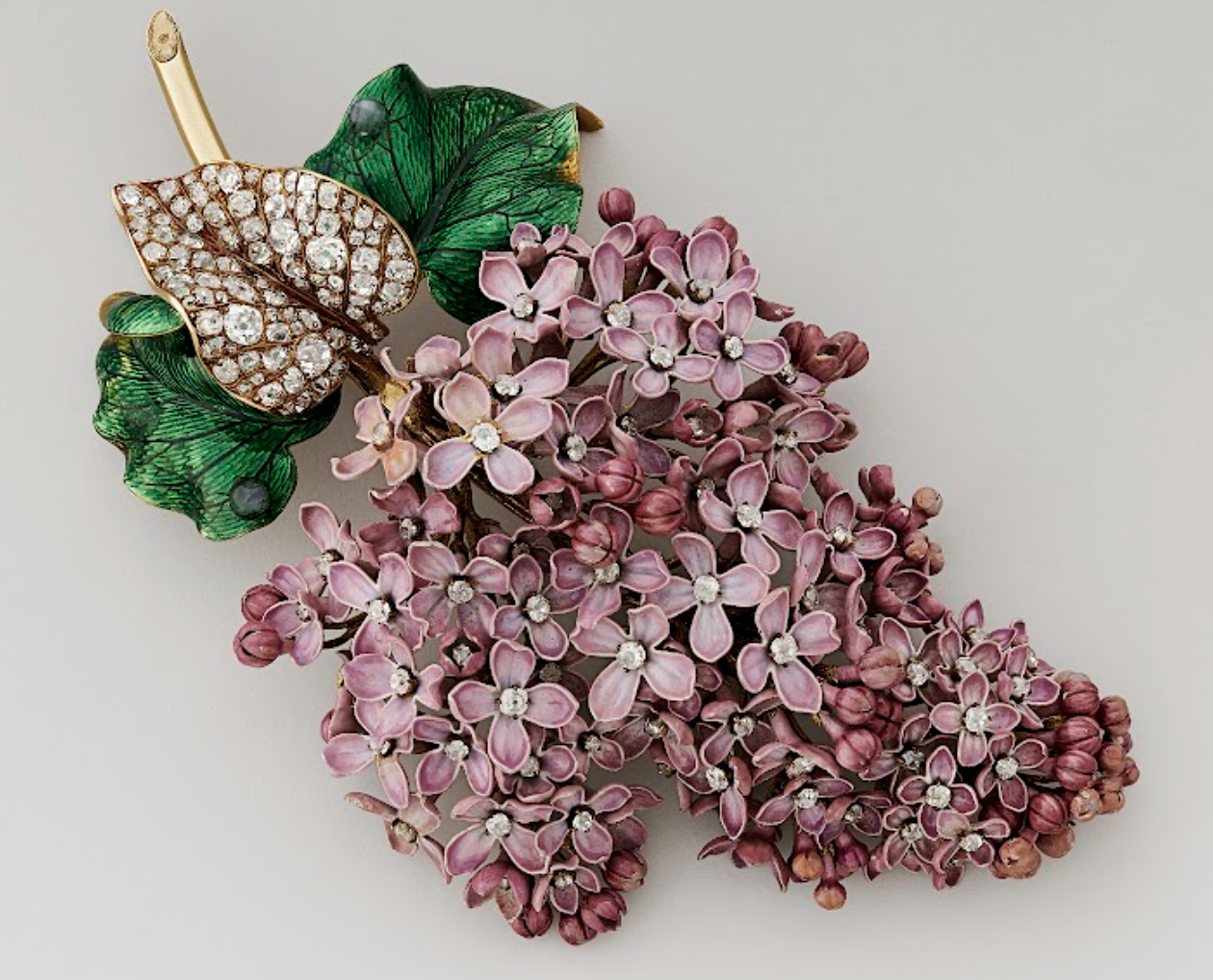 A brooch featuring a spray of pink flowers