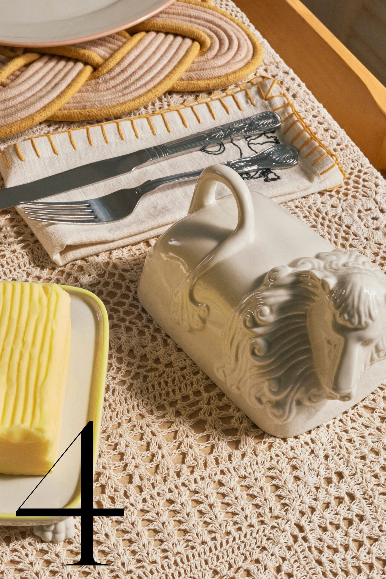 lion shaped butter keeper on crochet tablecloth