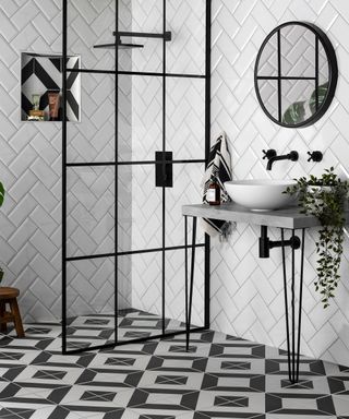 Monochrome shower with contrasting black and white wall tiles and shower tiles by Walls and Floors