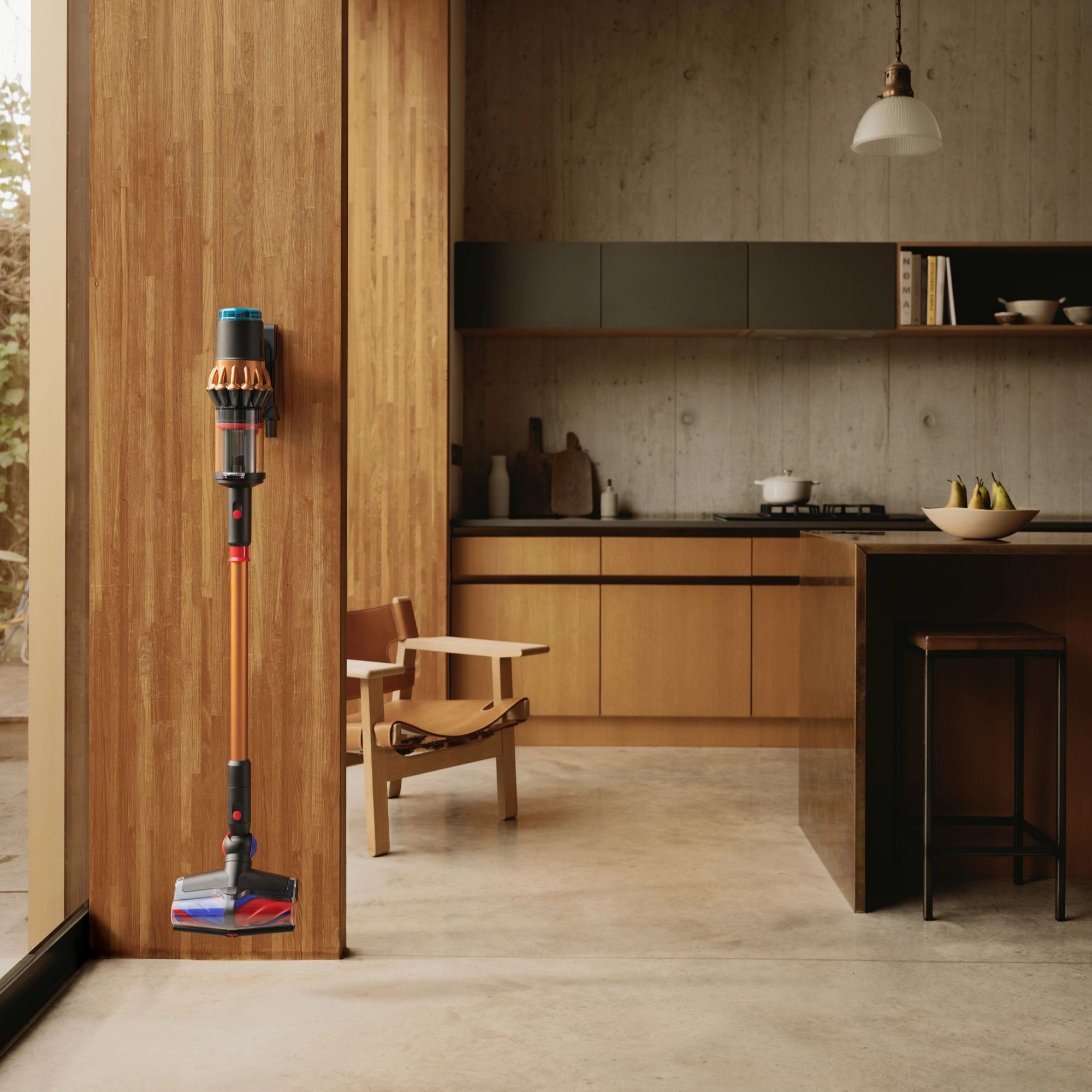 Dyson V16 Piston Animal vacuum on the docking station in a wooden kitchen with concrete floors