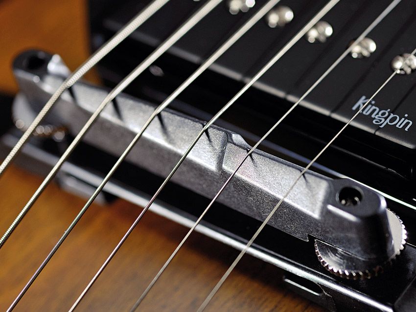 The high two-piece bridge will necessitate some adjustment to your playing style.
