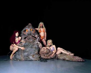 Three ladies in bikinis with Jabba the Hutt