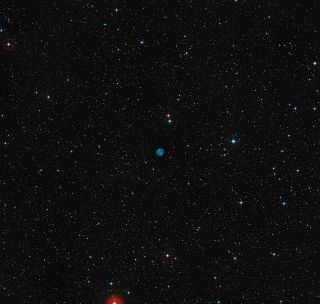 The sky around the planetary nebula ESO 378-1, the Southern Owl Nebula. The nebula is the blue disk at the picture's center. The picture was created from images in the Digitized Sky Survey 2.
