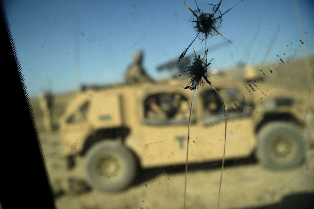 U.S. Army soldiers from NATO are seen through a cracked window of an armed vehicle in a checkpoint in Afghanistan.