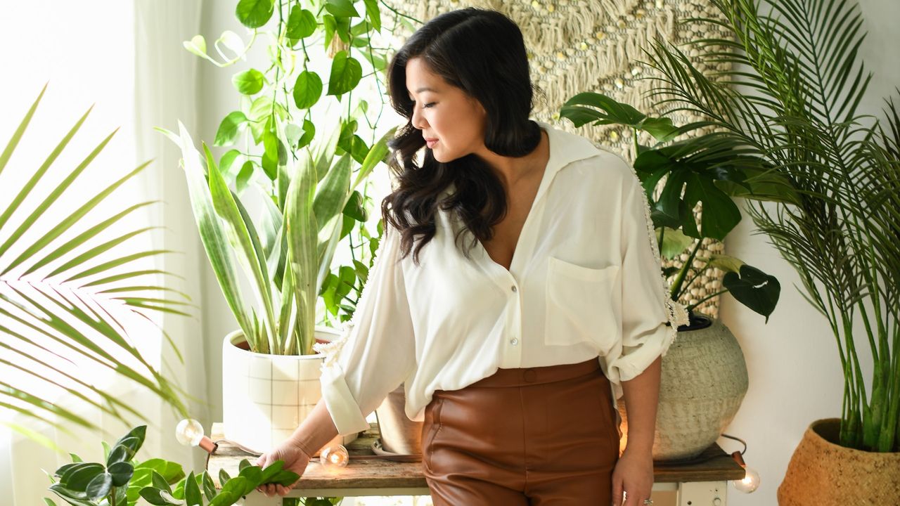 A woman tending to her indoor plants