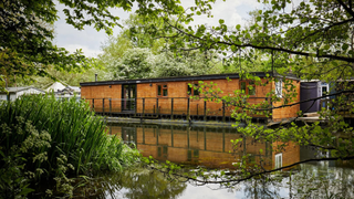 A smart wooden-clad riverboat home
