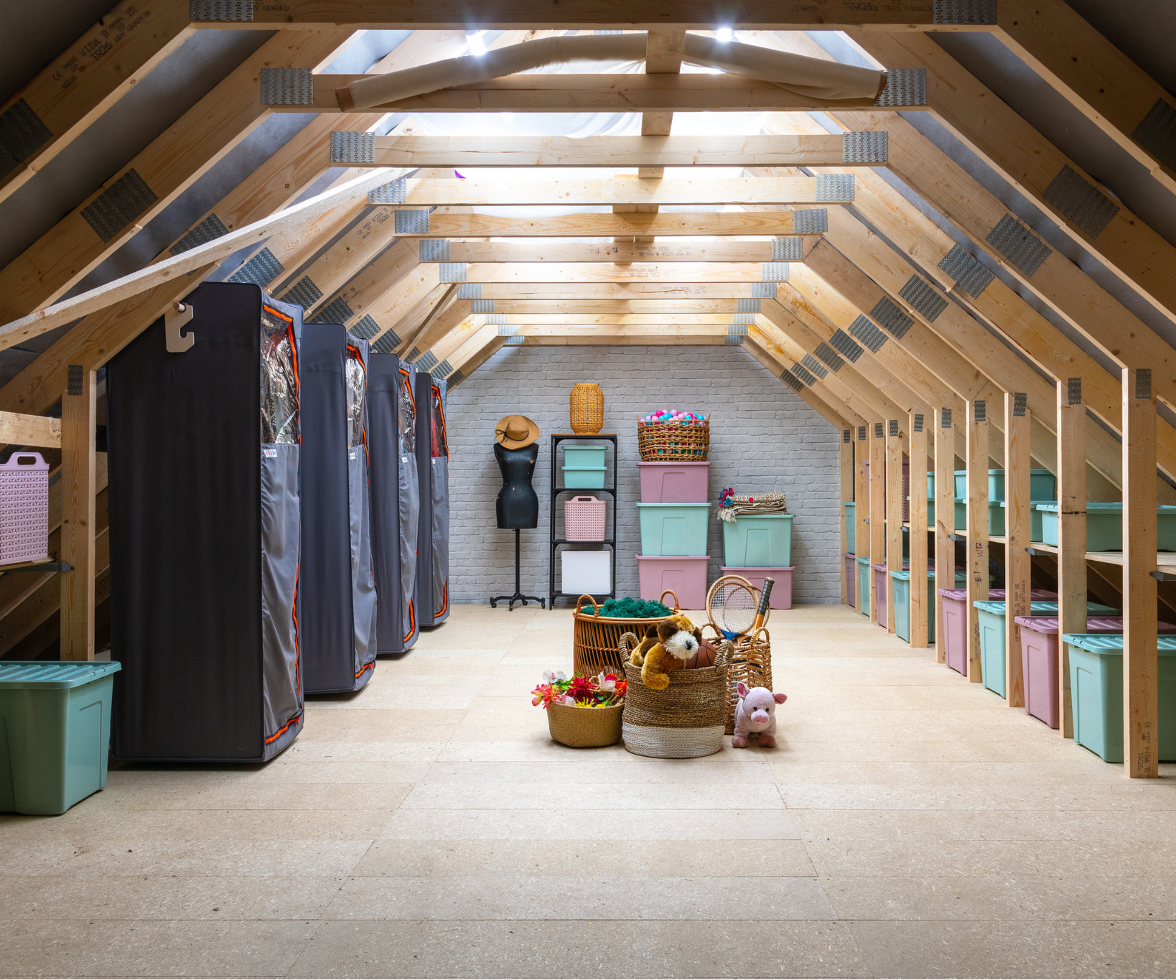 loft boarded out with hanging rails and wardrobes in trusses