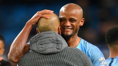 Manchester City captain Vincent Kompany is congratulated by manager Pep Guardiola