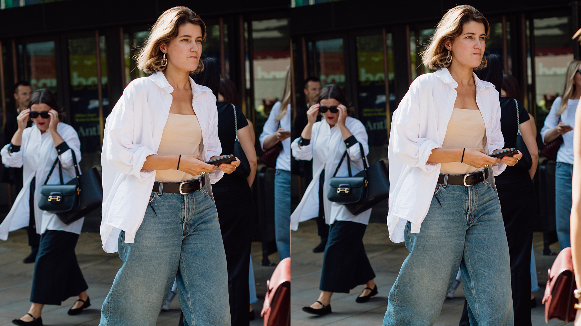 Woman is walking wearing jeans, tube top, and open white button down shirt