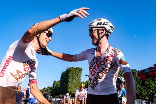 Ben O'Connor celebrates with teammate Michael Schar on Paris's Champs-Élysées