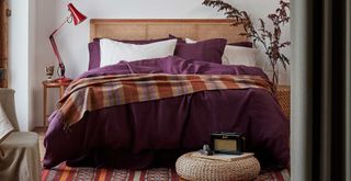 Cosy bedroom with berry coloured bedding