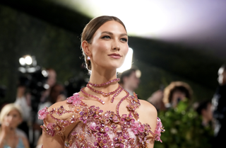 Karlie Kloss at the met gala with a bun in a pink dress