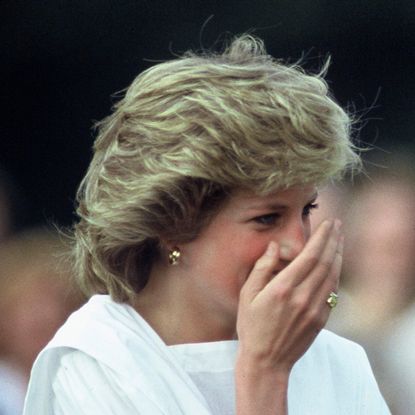 Princess Diana laughing and covering her mouth