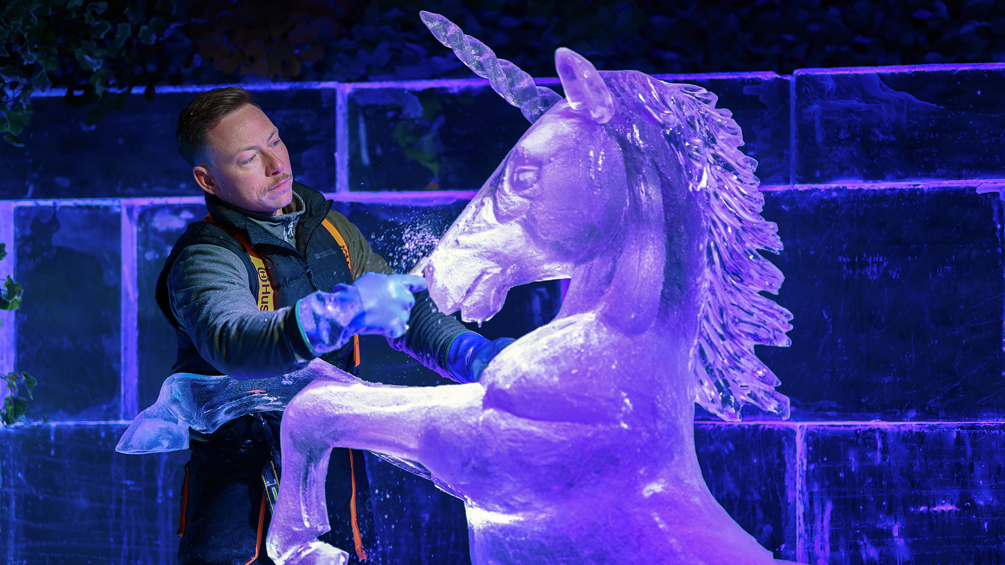 An artist sculpts a unicorn from solid ice at an ice bar in Edinburgh, Scotland