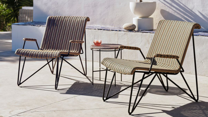 Two rattan garden chairs on a patio
