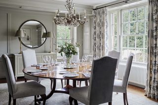 traditional dining room with chandelier, sideboard and mirror