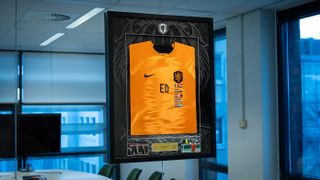 A framed Netherlands Shirt with 'ED' written in the middle.