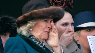 Queen Camilla and Zara Phillips watch the 'Queen Mother Champion Steeple Chase' horse race on day 2 'Ladies Day' of the Cheltenham Horse Racing Festival