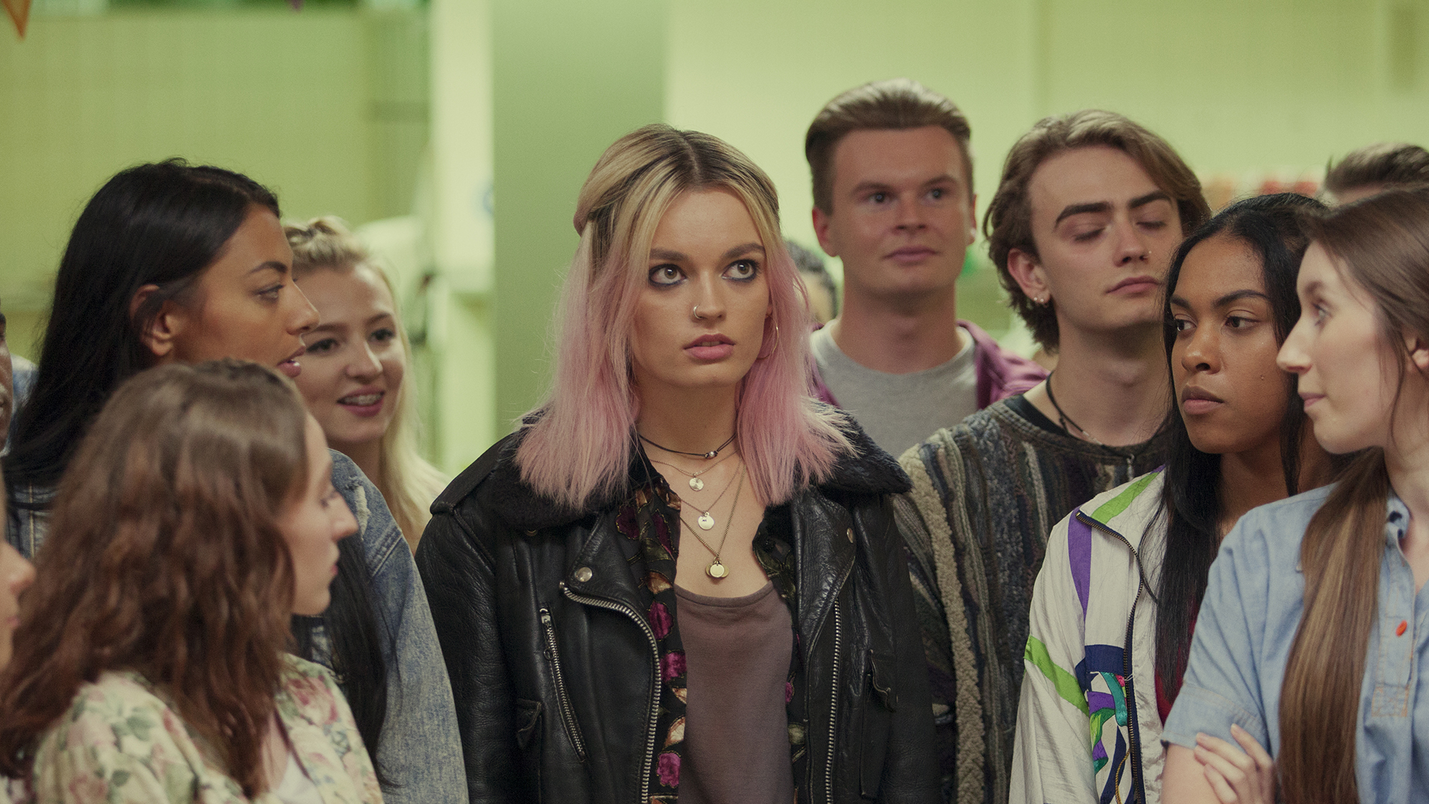 Emma Mackie as Maeve, surrounded by her peers, in sex education