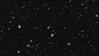 a deep-sky image showing hundreds of distant galaxies