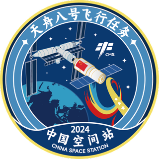 a patch showing a cross shaped space station in orbit above Earth and lots of Chinese characters