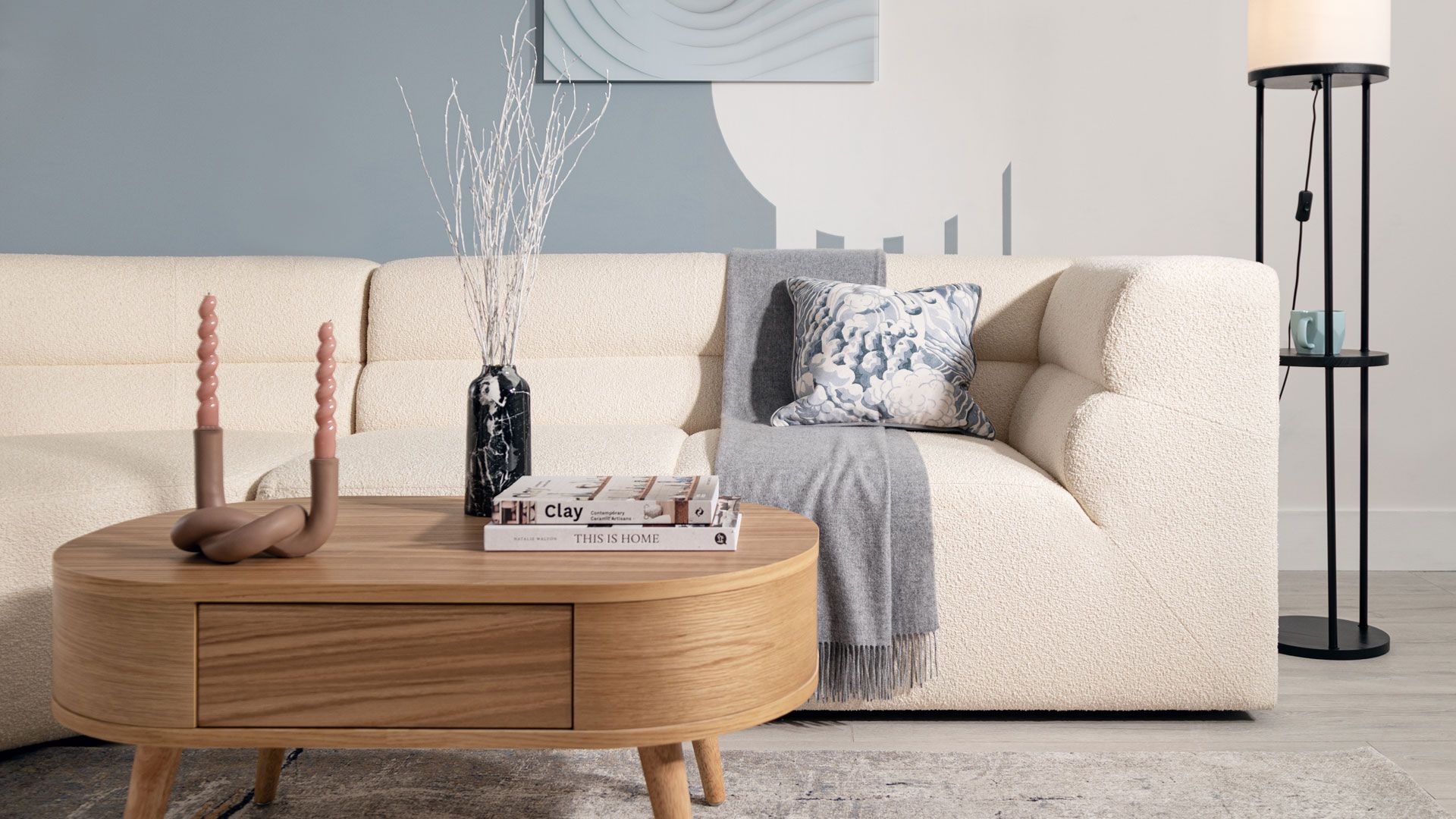 curved sofa in soft blue room living room trends 2023