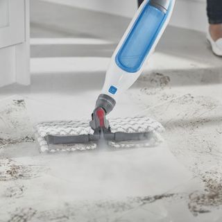 Closeup of a steam mop cleaning a tiled floor
