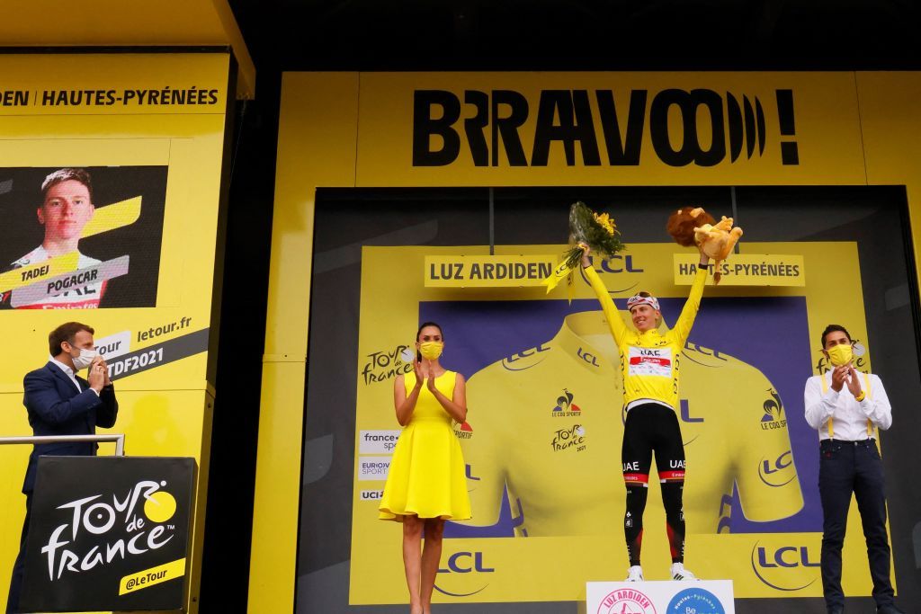 French President Emmanuel Macron applauds L as Team UAE Emirates Tadej Pogacar of Slovenia celebrates his overall leader yellow jersey on the podium at the end of the 18th stage of the 108th edition of the Tour de France cycling race 129 km between Pau and Luz Ardiden on July 15 2021 Photo by Thomas SAMSON AFP Photo by THOMAS SAMSONAFP via Getty Images