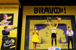 French President Emmanuel Macron applauds L as Team UAE Emirates Tadej Pogacar of Slovenia celebrates his overall leader yellow jersey on the podium at the end of the 18th stage of the 108th edition of the Tour de France cycling race 129 km between Pau and Luz Ardiden on July 15 2021 Photo by Thomas SAMSON AFP Photo by THOMAS SAMSONAFP via Getty Images