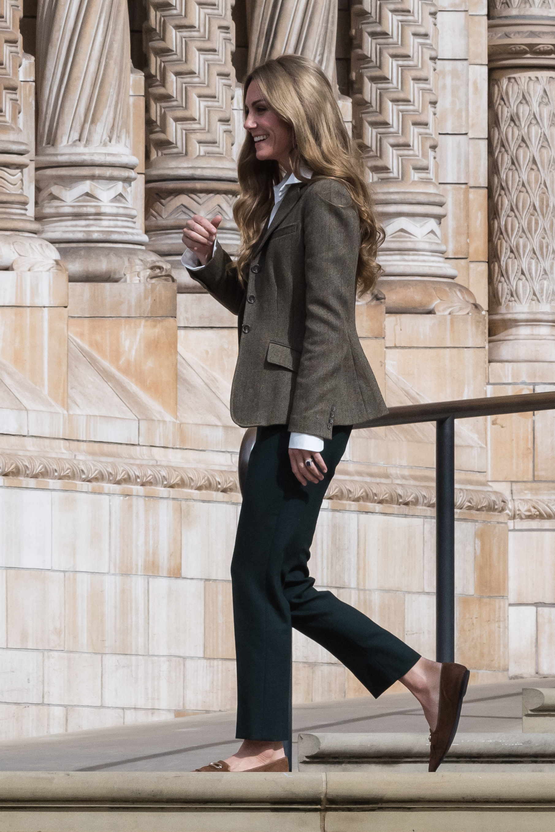 Kate Middleton walking outside the Natural History Museum in a blazer and pants